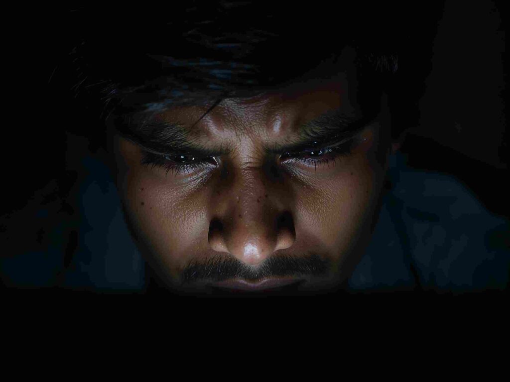 a frustrated Indian youth looking at a low bank balance on screen
